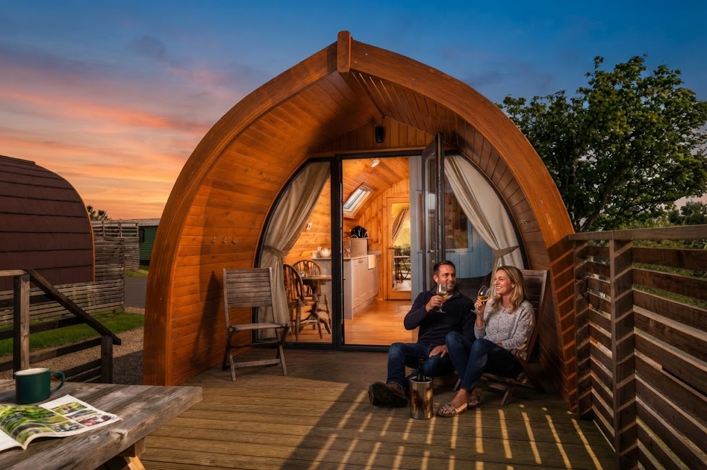 Bell tents on a budget Lake District glamping site in summer with a shared camp kitchen under a canopy
