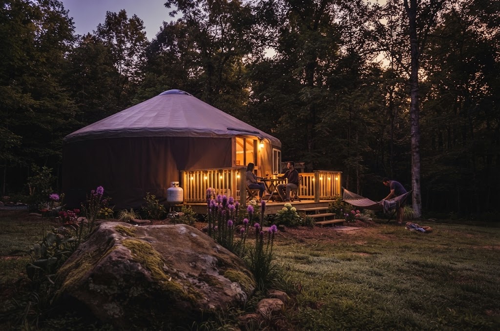 Camping pods on a terraced site above Lake Windermere with the water and western fells beyond